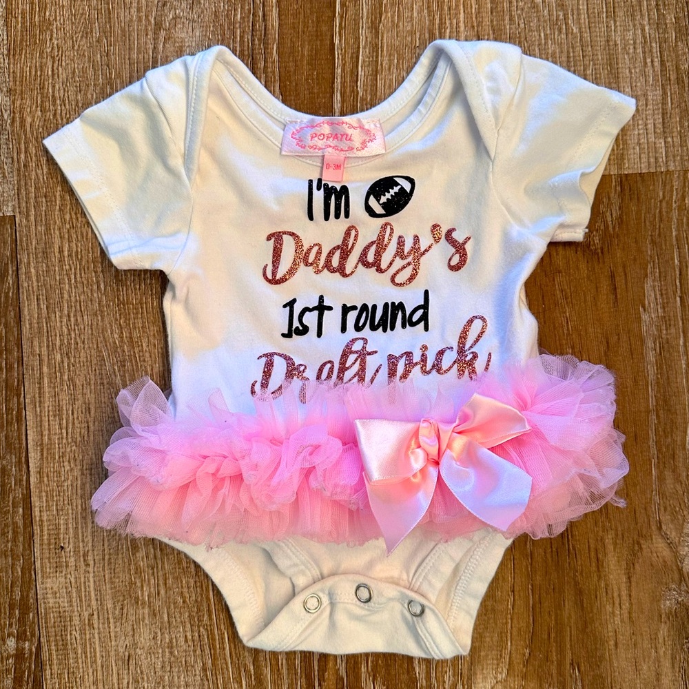 Baby onesie with pink tutu